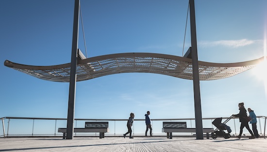 Agde, France - January 01, 2019: street atmosphere of the quays of the port of Agde where people are walking on a winter day @ credit Depositphotos