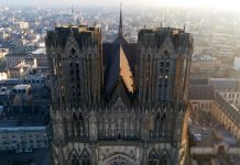 Ouverture fin 2025, Reims | Quadral Promotion annonce la fin des travaux de gros œuvre du futur hôtel TRIBE (ex-Univers) Aerial Close-Up of Reims Cathedral Towers and Gothic Details, France