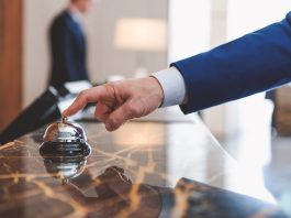 Hand of man using a hotel bell