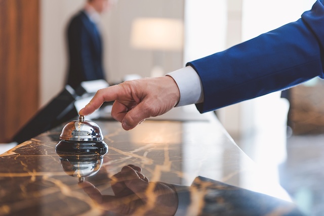 Hand of man using a hotel bell