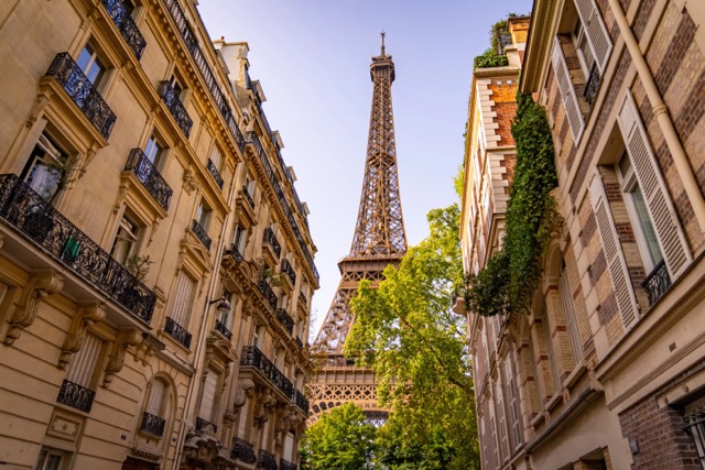 Beautiful view to the Eiffel Tower in Paris between the typical mansions@ credit Depositphotos.com