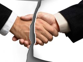 Two businessmen shaking hands @ credit depositphotos.com