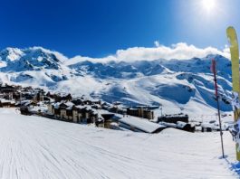 Ski in winter season, view from ski run at mountains and Val Thorens resort in sunny day in France, Alps.