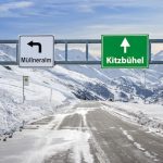 Austria ski town Mullneralm and Kitzbuhel road big sign with a lot of snow and mountain sky @ credit Depositphotos.com