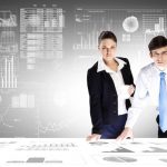 Businessman and businesswoman analyzing data information of market